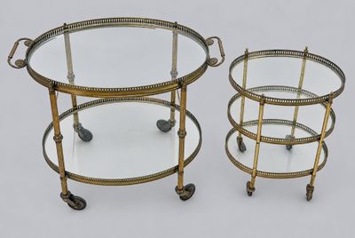 a pair of brass and glass drinks trolleys on casteors