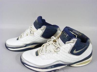 pair of white and blue basketball shoes on a white surface