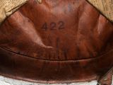 a brown leather purse with a tag on it