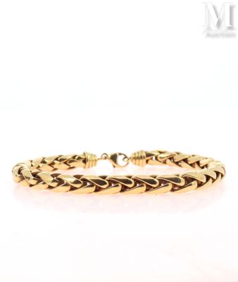 a close up of a gold bracelet on a white background
