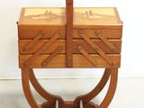 an image of a wooden box with a handle on a stand