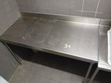 a sink and a counter in a public restroom
