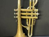 an old brass trumpet sitting on top of a table