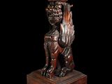 an image of a wooden table with a lion on it ' s legs