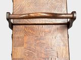 a wooden chair that has a wooden seat on top of it