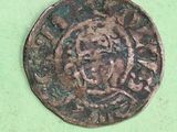 a close up of an old coin on a green surface