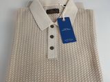 a close up of a white sweater with a blue tag on it