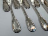 six spoons that are sitting on a table