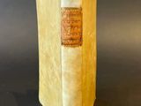an old book sitting on top of a table with a black background