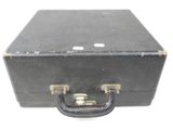 a black suitcase that is sitting on a white surface