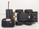 a toy truck with four wheels and a remote control