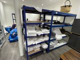 a room that has a bunch of shelves with towels on them