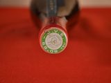 a close up of a bottle of wine on a red cloth