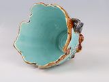 a blue bowl with a gold decoration on it