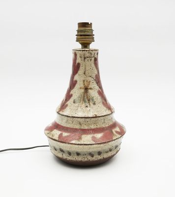 a red and white vase with a light on it