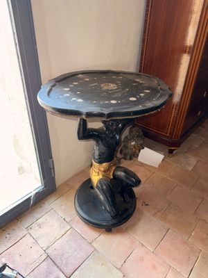 un chat assis sur une table dans un coin de la pièce