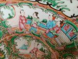 a close up of a decorative plate with people on it