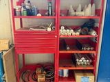 a red shelving with lots of items on it