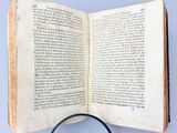 an open book with a magnifying glass on top of it