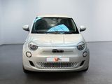 a small white car that is parked in a room