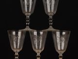 many wine glasses sitting on a shelf in a room