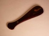 a wooden spoon with a handle on a table