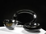 two bowls and a plate sitting on a white table
