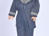 a doll of a boy in a sailor suit and hat