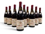 six bouteilles de vin sont alignées sur une surface blanche
