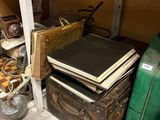 a pile of old suitcases and other items on the floor
