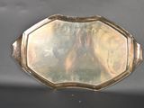 a silver tray with a mirror on it on a table