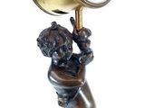 a statue of a boy holding a clock on his head