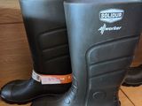 a pair of rubber boots on a shelf in a store
