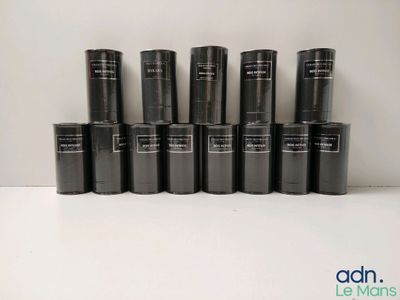 Plusieurs tubes de rouge à lèvres noir sont alignés sur une surface blanche