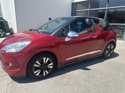 a red citrole parked in front of a building