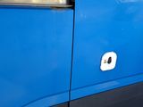 a close up of a door handle on a blue bus