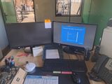 un bureau sur lequel sont posés deux écrans d'ordinateur et un clavier