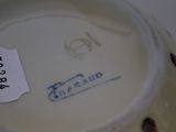 a close up of a vase with a tag on it