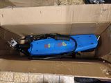 a blue electric scooter sitting in a cardboard box