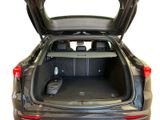 the back of a car with its trunk open and luggage in the trunk