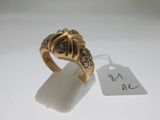 an image of a gold ring with black diamonds on a white surface