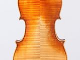 an old violin with a wooden back and a long neck