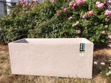 a planter sitting in the middle of the grass