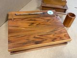 a wooden desk with a pen and a cup on it