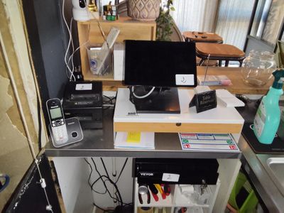 a desk with a laptop and a printer on top of it