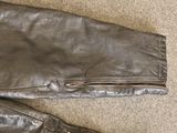 a pair of leather pants that are laying on the floor