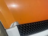 an orange and white van parked in a parking lot