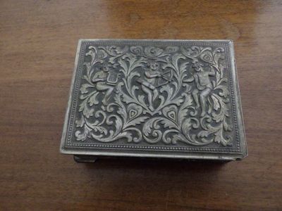 a silver box sitting on a wooden table