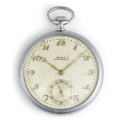 a close up of a pocket watch on a white surface