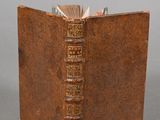 an old book that is open on a table